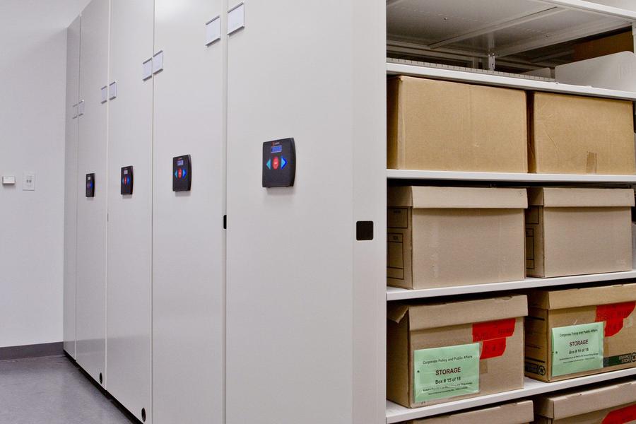 Mobile shelving with archive boxes and electronic control display.