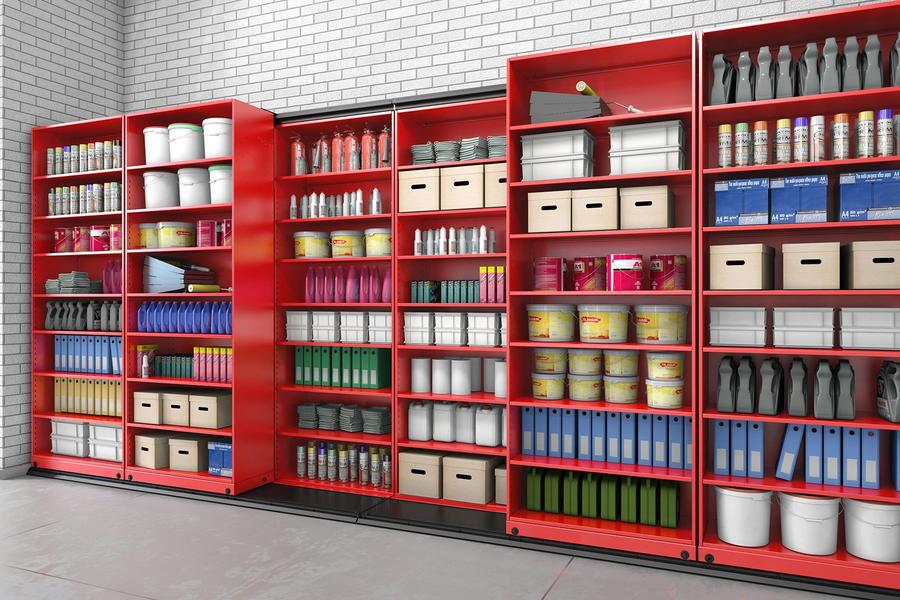 Red shelving with various storage items.