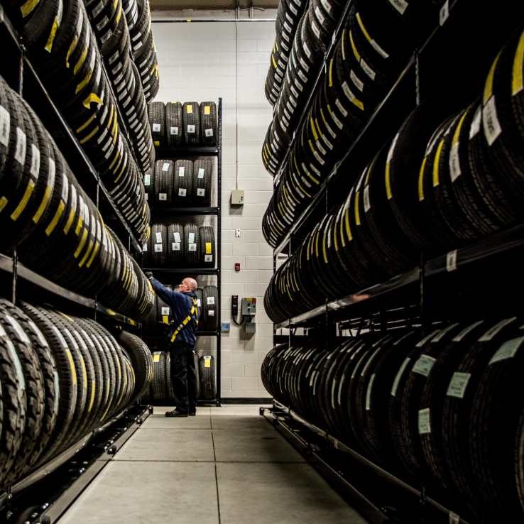 Montel employee inspecting tires in a warehouse.