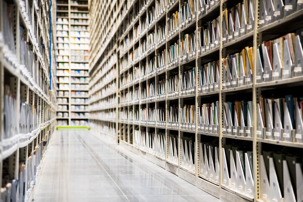 Long row of storage shelves with files, illustrating an efficient storage system.