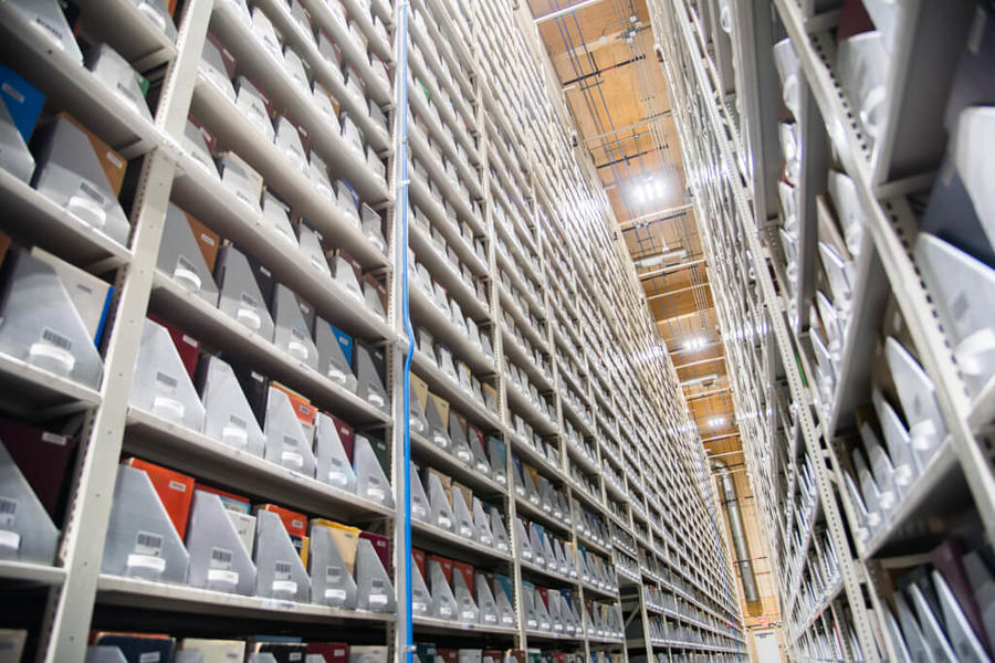 Vertical view of library shelves reaching the ceiling.