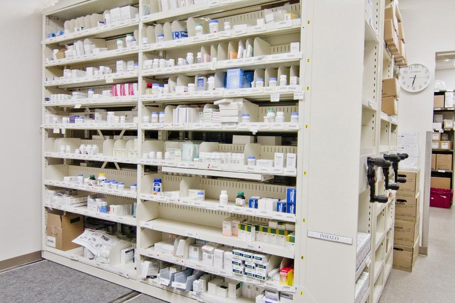 Fixed shelving for organizing medications and pharmaceutical products.