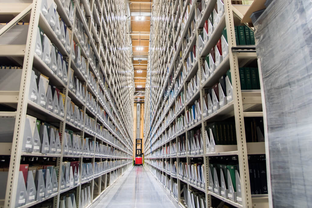 Perspective view of a storage aisle with neatly organized files on both sides.