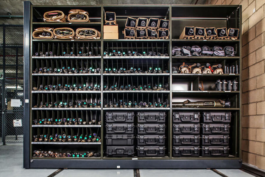 Storage shelving for police equipment, with various gear organized.