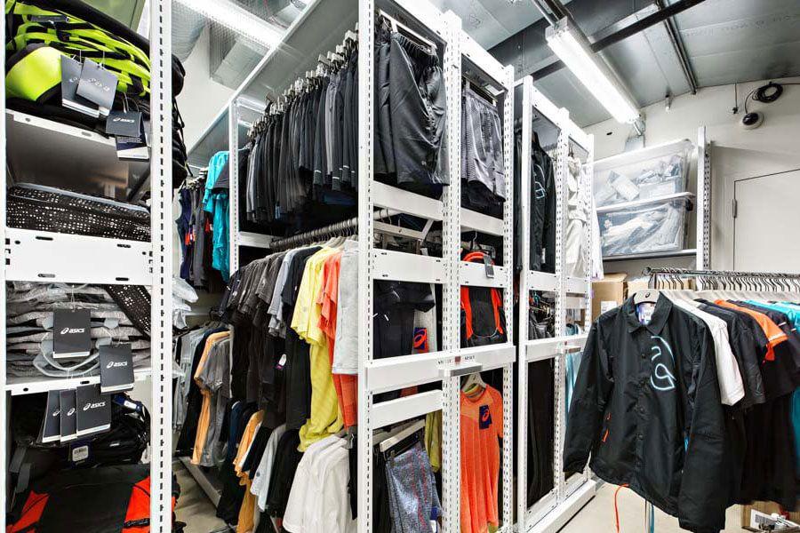 Clothing display on racks in retail storage.