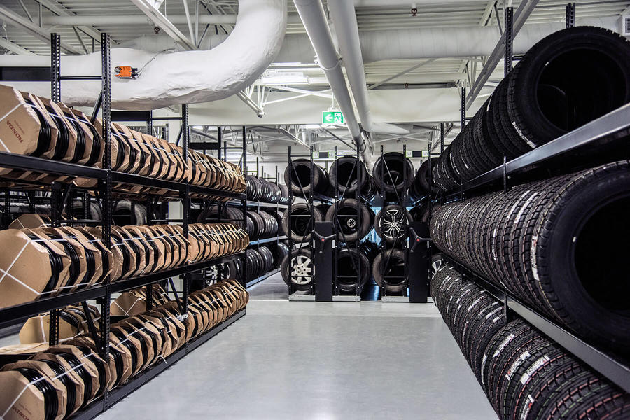 Tire warehouse with black shelving and mobile storage system