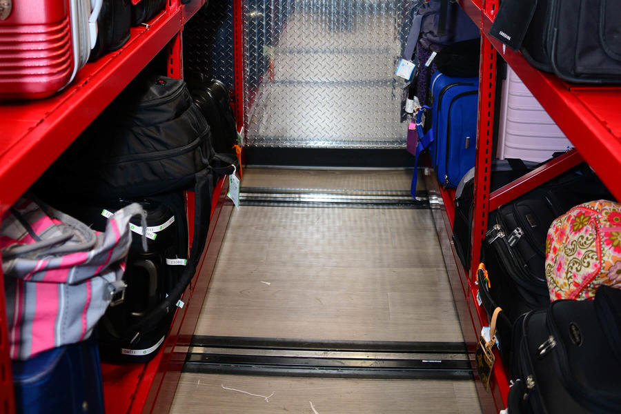 Luggage storage area with mobile shelving for easy access.