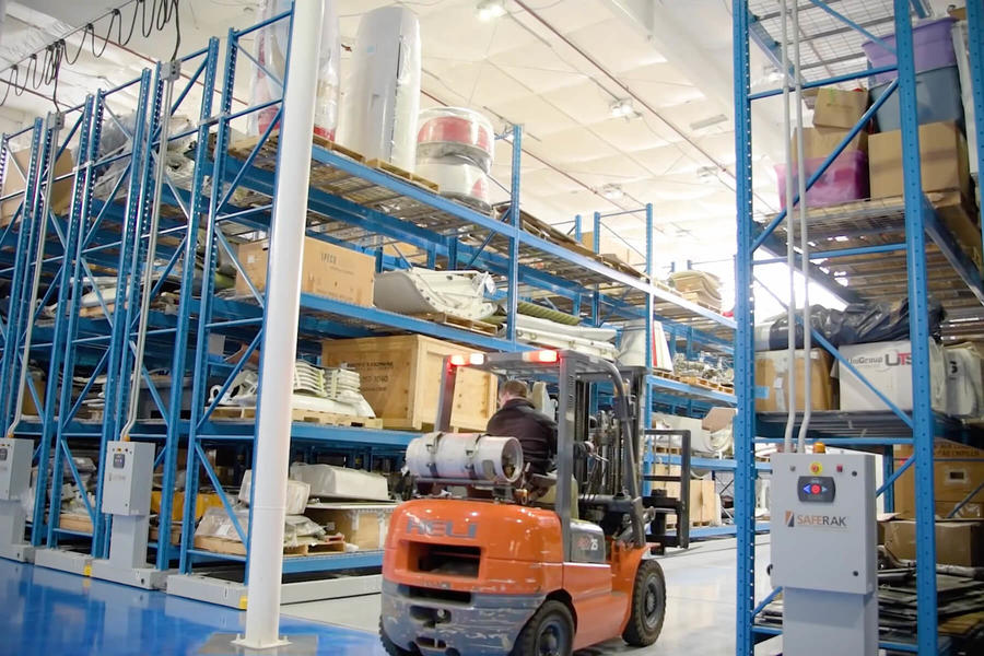 Forklift carrying materials in a warehouse.